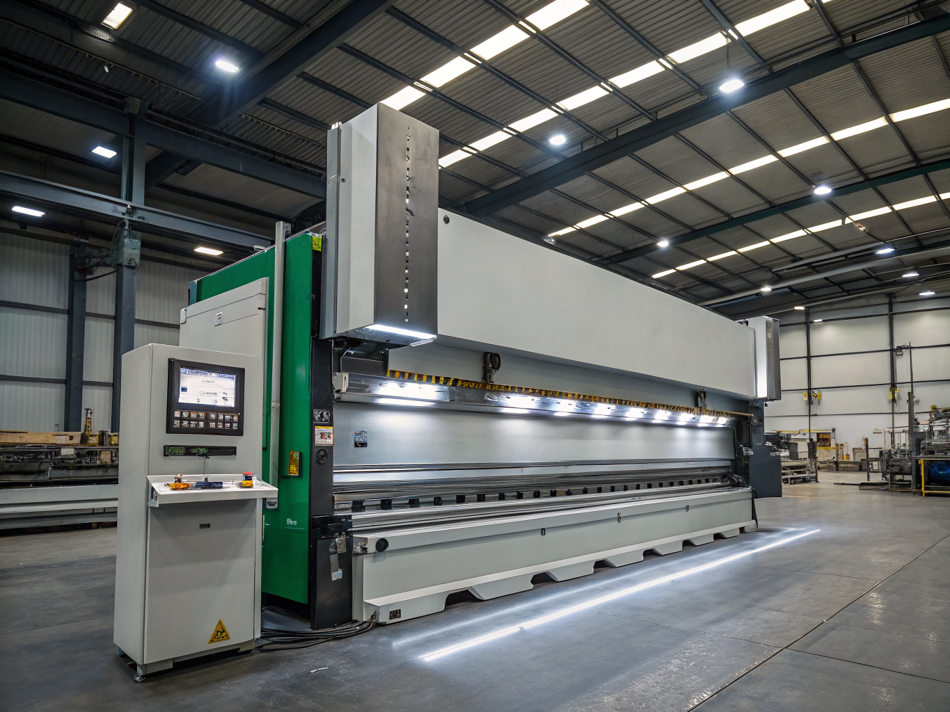 CNC press brake operator forming a metal component with high precision