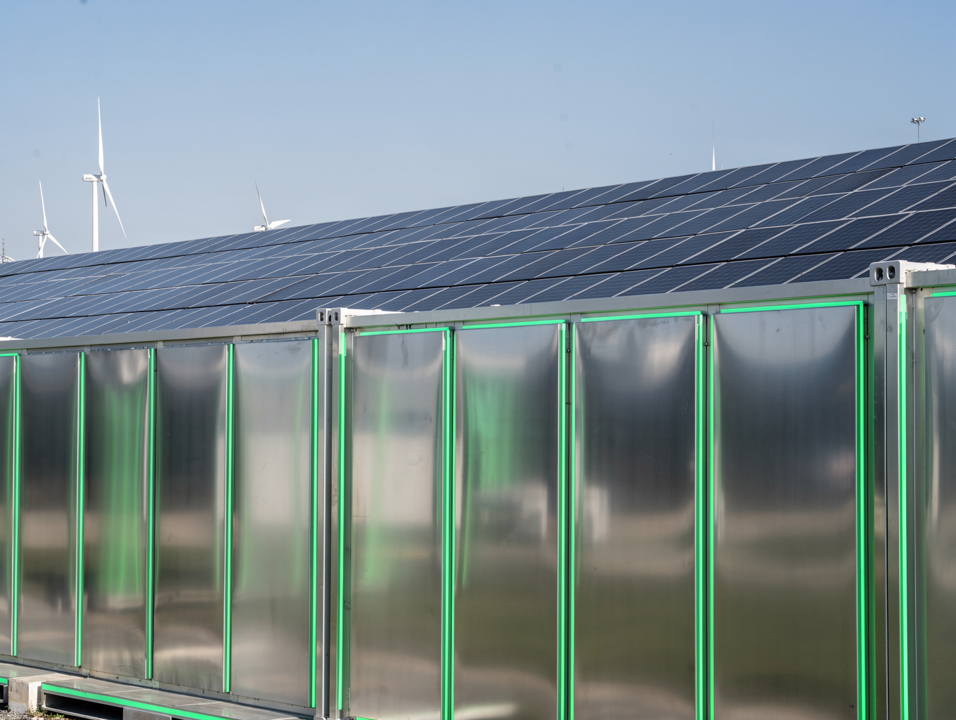 Lineup of multi-bay sheet metal energy storage cabinets at utility solar farm